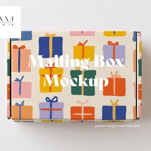 May include: A rectangular mailing box mockup with a repeating pattern of colorful gift boxes. The gifts are in shades of blue, yellow, orange, green, and pink, with contrasting ribbon colors. The text "Mailing Box Mockup" is displayed on the box.