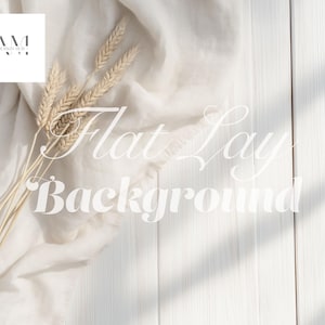 May include: A flat lay background featuring a white wooden surface, a beige linen cloth, and wheat stalks. The image includes the text "Flat Lay Background". The AM Design Hub logo is in the upper left corner.