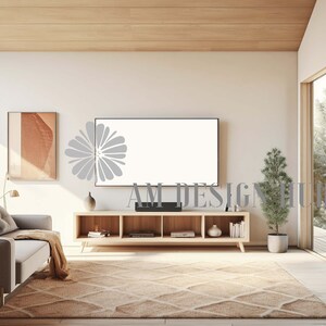 May include: A living room interior with a light wood floor, a light grey couch, a wooden TV stand with a flat screen TV, a small potted plant, and a framed picture on the wall.