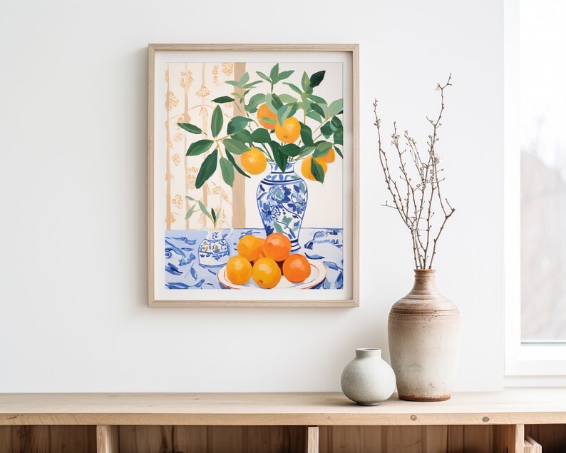 May include: A framed painting of a still life with a blue and white porcelain vase filled with orange blossoms and oranges on a blue and white tablecloth.