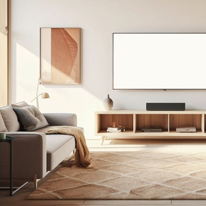 May include: A light beige living room with a gray sofa, a wooden entertainment center with a flat screen TV, and a beige rug with a geometric pattern. There is a framed print on the wall above the sofa.