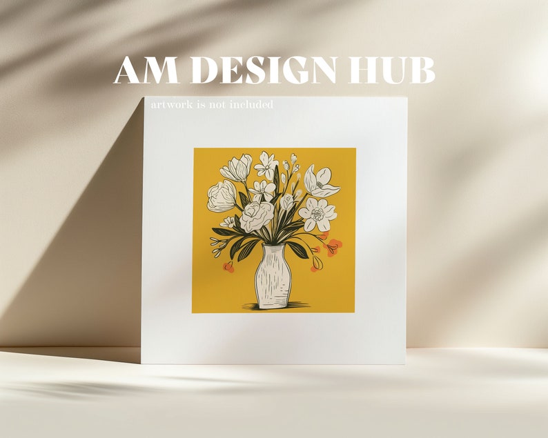 May include: A white vase with a bouquet of white flowers with orange accents on a yellow background. The text "AM DESIGN HUB" is at the top of the image and the text "artwork is not included" is below the image.
