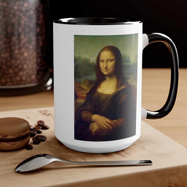 May include: White ceramic mug with a black rim and handle. The mug features a full-color image of the Mona Lisa painting.