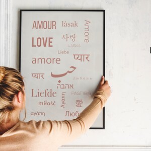 May include: A printable poster with the word "love" in English and the word for love in multiple other languages, including French, Spanish, German, Italian, and Japanese. The poster is printed in a light pink color on a white background.