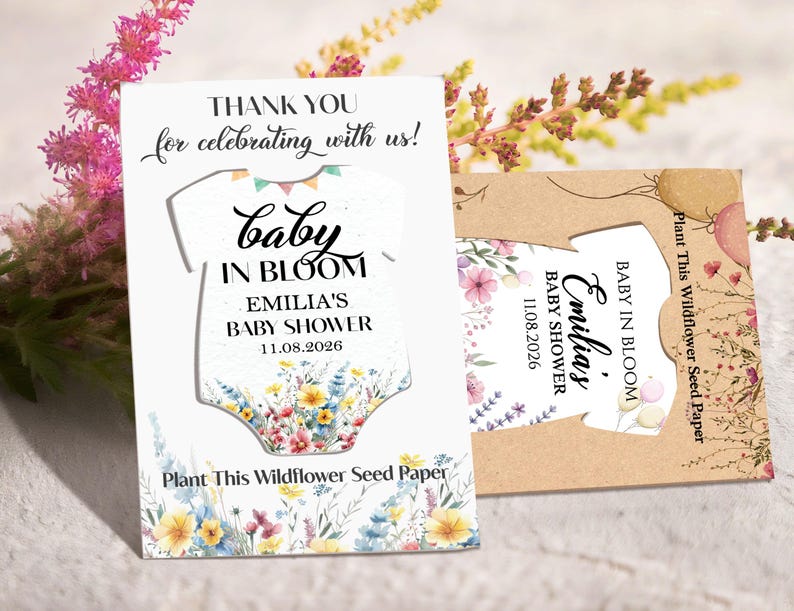 May include: Baby shower favor cards with a baby onesie cutout design. The white card features text that reads "Thank you for celebrating with us! Baby in Bloom, Emilia's Baby Shower 11.08.2026." The card is decorated with floral illustrations.