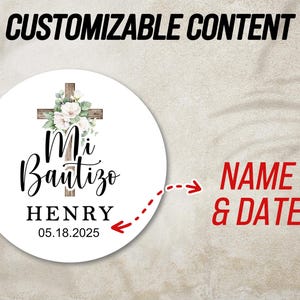 May include: White round sticker with a wooden cross decorated with white flowers. The text "Mi Bautizo" is written in black cursive lettering. Below the text is the name "HENRY" and the date "05.18.2025".