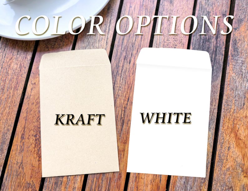 May include: Two small envelopes, one kraft and one white, are displayed on a wooden surface. The word "COLOR OPTIONS" is written above the envelopes. The kraft envelope has the word "KRAFT" printed on it, and the white envelope has the word "WHITE" printed on it.
