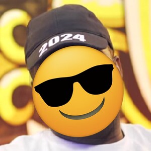 May include: A black cap with the year "2024" printed in white. The image features a yellow emoji with sunglasses covering the face. The background is blurred with yellow and white shapes.