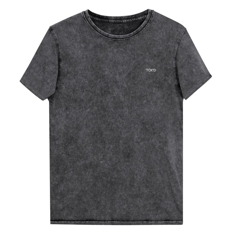 May include: A dark gray, acid-washed t-shirt with a small white embroidered logo that says "TOX'D".