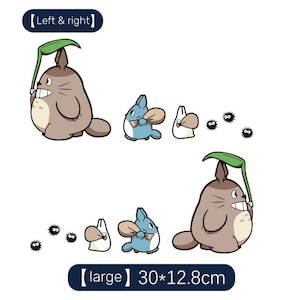 May include: Two illustrations of a brown Totoro character with a green leaf umbrella, a blue cat-like character with a brown sack, and a white bunny-like character with a brown sack. The illustrations are surrounded by black and white dust bunnies. The text "[large] 30*12.8cm" is below the second illustration.