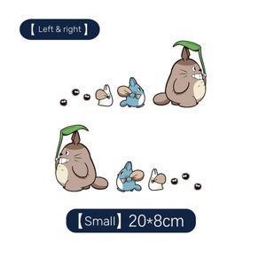 May include: A set of two Totoro character iron-on patches. The patches feature Totoro, a small blue cat-like creature, and a white bunny. The patches are 20 cm by 8 cm and are suitable for use on clothing, bags, or other fabric items.