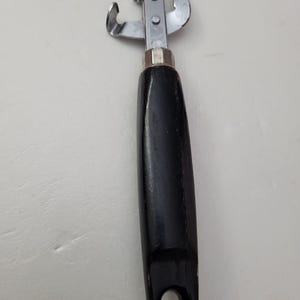 Ekco can opener with black wood handle