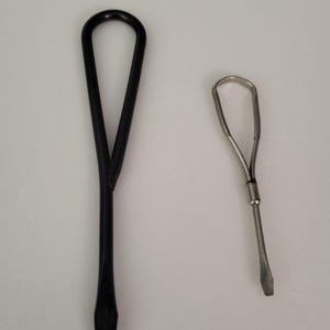 May include: Two screwdrivers, one black and one silver, with a loop at the top of the handle.