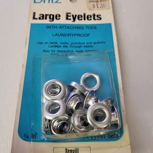 May include: Package of Dritz Large Eyelets with attaching tool. The package is blue and white and features a picture of the eyelets. The eyelets are silver and 1/4 inch in size. The package also includes the text "Laundryproof" and "Scovill".