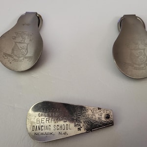 May include: Three vintage silver-toned metal dance cards. Two cards have a shield emblem and the word "SEMPER" engraved. The third card reads "SEASON'S GREETING BERRY'S DANCING SCHOOL NEWARK, N.J."