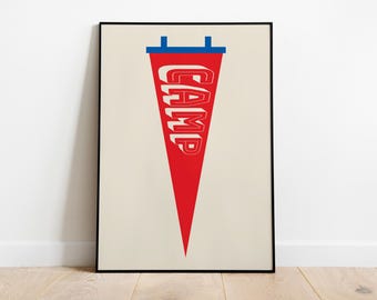 May include: A framed wall art print featuring a red triangular pennant with the word CAMP written in white block letters. The pennant has a blue horizontal bar at the top with two small blue tabs extending upward, all set against a cream background.