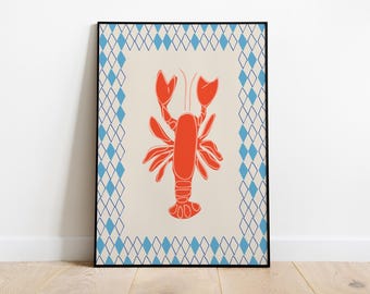 May include: A rectangular wall art print featuring a centred orange lobster illustration on a cream background. The print is enclosed by a blue diamond-patterned border and a thin black frame, creating a clean and balanced visual composition.