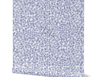 May include: A roll of wallpaper featuring a dense, repeating hand-drawn pattern of small blue flowers and delicate leafy stems on a solid white background. The design covers the entire surface of the paper with a consistent, intricate botanical motif.
