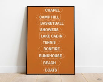 May include: A rectangular wall art print with a burnt orange background featuring ten white directional sign graphics stacked vertically. The signs contain the text: CHAPEL, CAMP HILL, BASKETBALL, SHOWERS, LAKE CABIN, TENNIS, BONFIRE, BUNKHOUSE, BEACH, and BOATS.