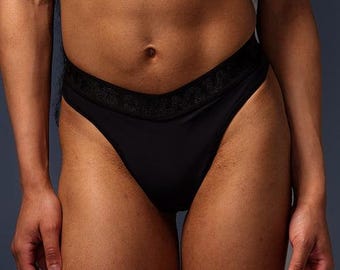 May include: Black high-waisted underwear with a wide waistband and a smooth, sleek fabric.