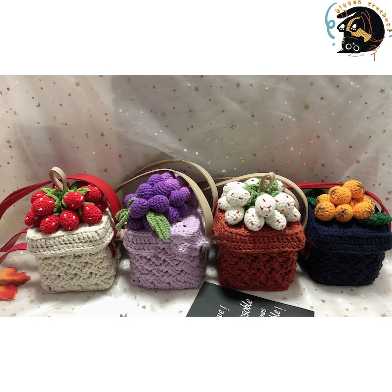 May include: Four crocheted mini bags with different fruit designs. The bags are white, purple, orange, and blue. Each bag has a crocheted strap.