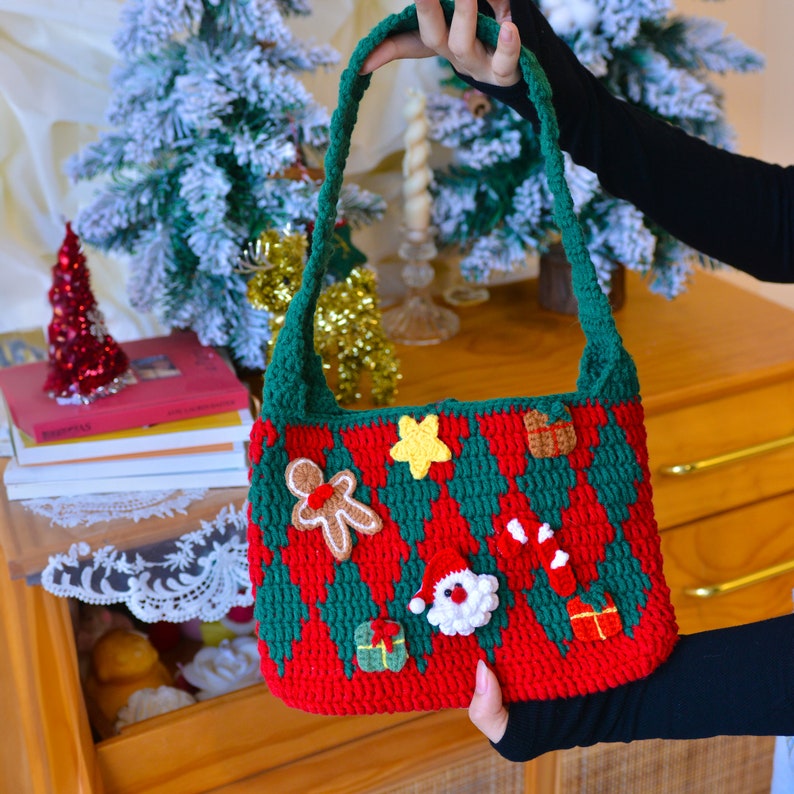 May include: A red and green crocheted Christmas-themed tote bag with a gingerbread man, a star, a candy cane, a Santa Claus, and a gift box.