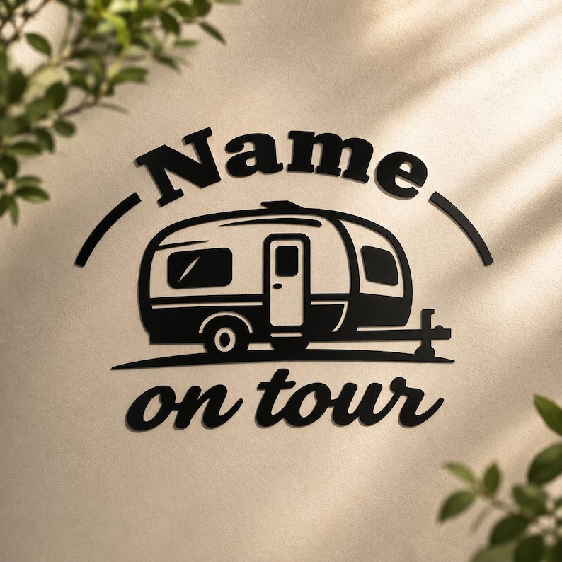 May include: Black and white camper silhouette with the text "Name" above and "on tour" below. The camper has a door, windows, and wheels. The design is on a light beige background.