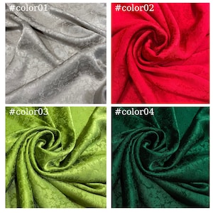 May include: Four fabric swatches in different colors: silver, red, green, and dark green. Each swatch has a textured, floral pattern.