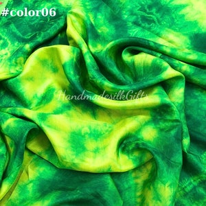 May include: A vibrant green and yellow silk fabric with a tie-dye pattern. The fabric is draped, showing the texture and flow of the material. The text "#color06" is in the top left corner, and "HandmadesilkGifts" is in the center.