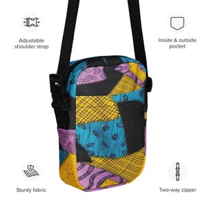 May include: A black crossbody bag with a patchwork design featuring yellow, blue, and purple squares. The bag has an adjustable shoulder strap, an inside and outside pocket, and a two-way zipper.