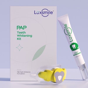 May include: A white box with the text "Luxsmile" and "PAP Teeth Whitening Kit" on it. A white tube with the text "Luxsmile" and "PAP+" on it. A yellow and gray mouth guard.