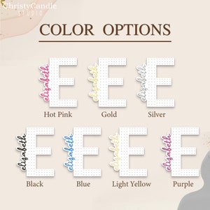 May include: Color options for a personalized "Elizabeth" name sign. The sign is white with black dots and features the name in various colors: hot pink, gold, silver, black, blue, light yellow, and purple.