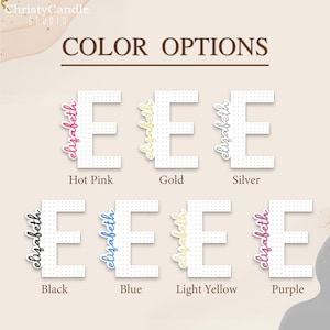 May include: Colour options for a personalised "Elizabeth" name sign. The sign is white with black dots and features the name in various colours: hot pink, gold, silver, black, blue, light yellow, and purple.