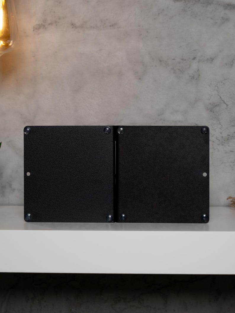 May include: A pair of black metal bookends with a simple, modern design. The bookends are made of a sturdy metal and have a smooth, matte finish.