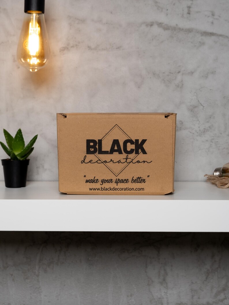 May include: A brown cardboard box with the text "BLACK decoration" and the tagline "make your space better" printed on it. The website address "www.blackdecoration.com" is also printed on the box.