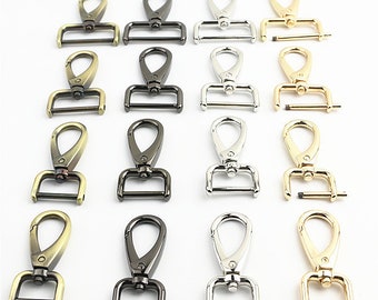 May include: Assortment of 12 metal swivel clasps in antique brass, black nickel, silver, and gold finishes. Each clasp features a spring-loaded gate and a rectangular loop.