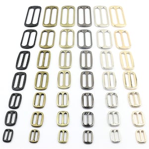 Puede incluir: Surtido de hebillas deslizantes de metal en varios tamaños y acabados, incluyendo negro, plata, oro y latón antiguo.