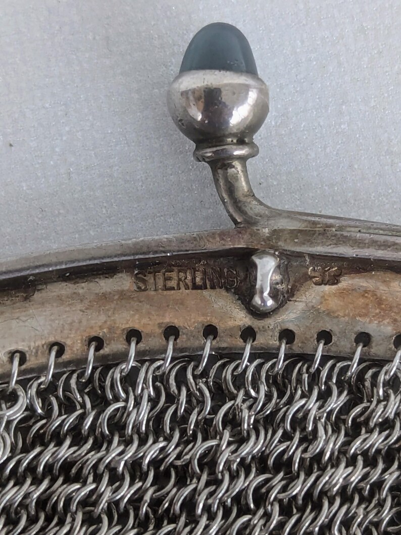 May include: A silver mesh purse with a sterling silver clasp and a blue stone top.