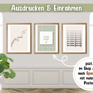 May include: Three framed prints with motivational quotes. The prints are hanging on a wall with white wainscoting. The prints are in a light wood frame. The text on the prints reads: "Finding yourself is not always easy", "Reminder: I'm in recovery, too. I'm not always going to be perfect. Be patient with me. Reminder", and "Du bist genug".