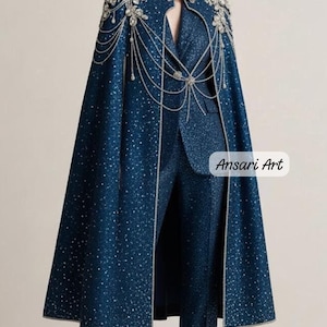 May include: A navy blue ensemble featuring a sparkling cape with silver embellishments and a matching suit. The cape has a high collar and is adorned with intricate beadwork. The text "Ansari Art" is visible.