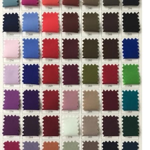 May include: A color chart featuring a variety of fabric swatches in a range of colors, including shades of blue, red, green, purple, and neutral tones. Each swatch is labeled with a number, providing a comprehensive color selection guide.
