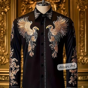 May include: Black button-down shirt with gold embroidered eagle designs on the front and sleeves. The shirt features a detailed collar and cuffs, with a line of small white embellishments down the front. The text "Ansari Art" is visible on the lower right.