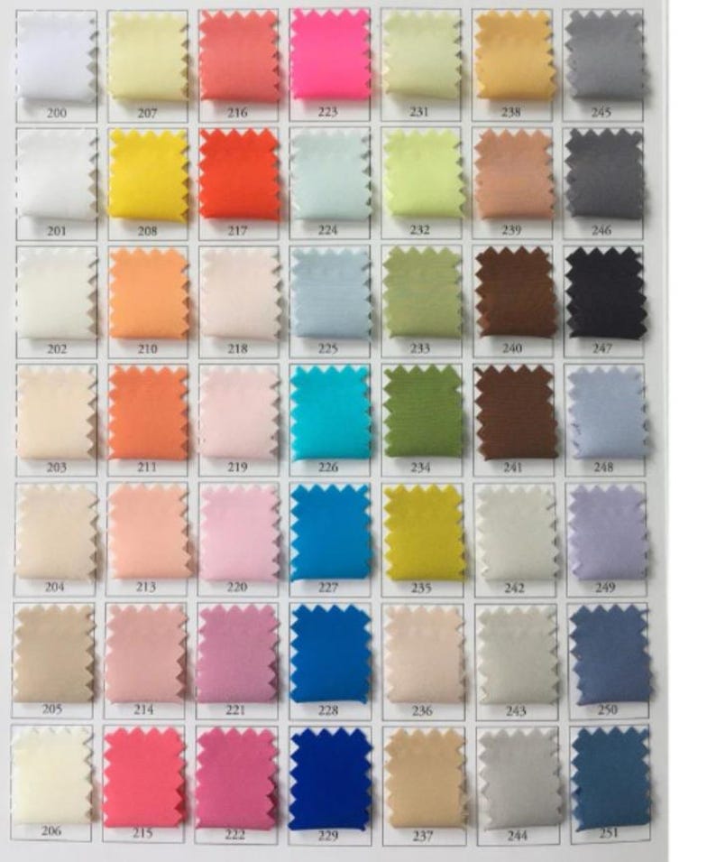 May include: A fabric color chart featuring a grid of 48 swatches in various shades. The swatches include a range of colors, from white and yellow to pink, blue, and green. Each swatch is labeled with a number, likely for color identification.
