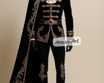 May include: A black velvet suit with gold embroidery, a matching cape, and black boots. The suit features ornate gold detailing on the jacket, pants, and cape. The jacket has gold buttons and a decorative belt. The text "Ansari Art" is visible.