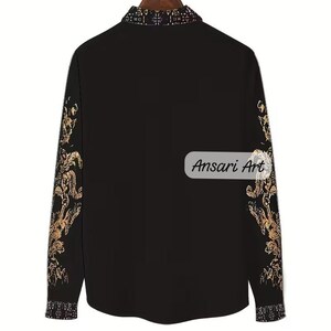 May include: Black button-down shirt with gold floral patterns on the sleeves and collar. The shirt has the text "Ansari Art" on the lower right side. The collar and cuffs have a patterned design.