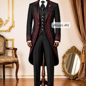 May include: A black tailcoat suit featuring intricate red embroidery along the lapels and cuffs, paired with a matching waistcoat with silver buttons, a white shirt, a black tie, and black trousers. The text Ansari Art is visible on the right side.