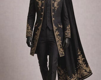 May include: A black formal suit with gold embroidery, including a long coat, vest, and trousers. The coat features ornate gold detailing on the shoulders, cuffs, and front. A black cape with gold embellishments drapes over the suit. The mannequin wears black gloves and shoes.
