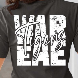 May include: A dark gray t-shirt with a white distressed graphic that reads "WAR Tigers EAE".