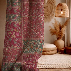 May include: A patterned curtain with a patchwork design. The curtain features a mix of red and green floral patterns. The design includes various floral motifs and botanical elements, creating a vintage aesthetic. The curtain is hanging in a room with a warm, inviting atmosphere.