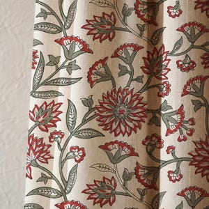 May include: Cream-colored fabric with a repeating floral pattern. The design features red flowers with gray centers and green stems and leaves. The fabric appears to be a curtain or drapery material.